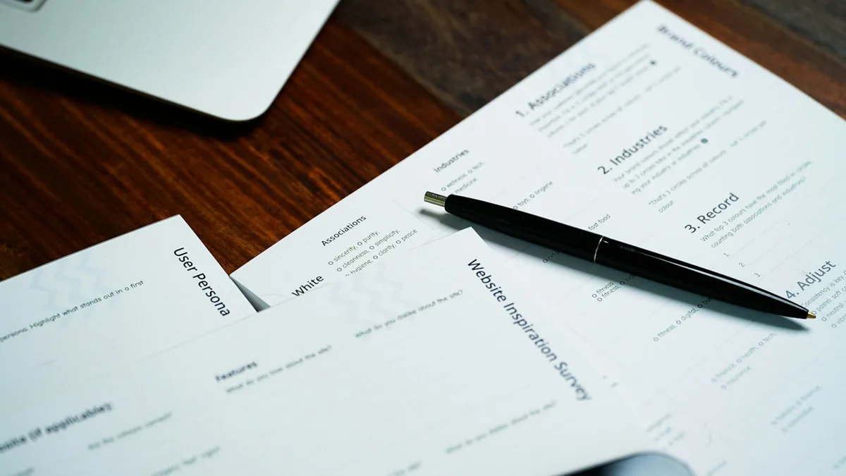 A pen and planning papers on a desk