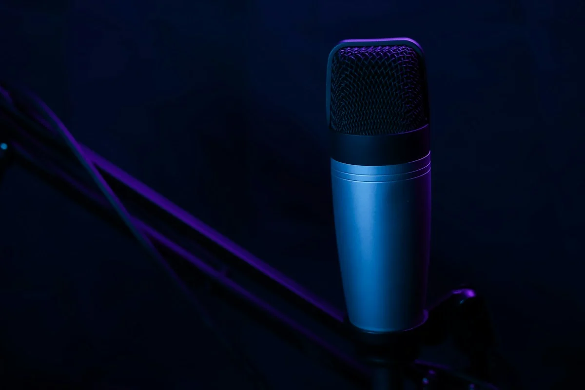A microphone lit in blue, illustrating a community discussion